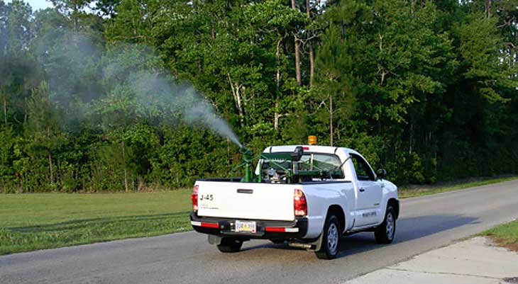 Image of white truck spraying chemicals